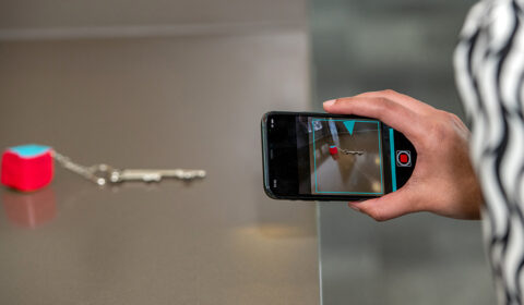 Find My Things - close up of a person's hand taking a photo of keys on a table