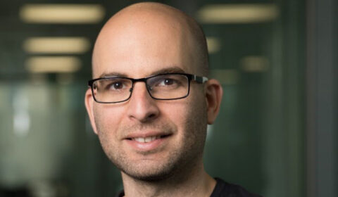 Ariel Gomez Diaz wearing glasses and smiling at the camera
