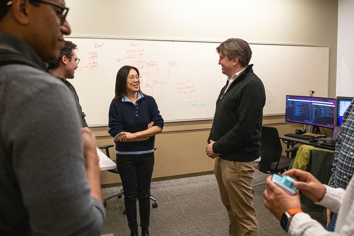 Andrey Kolobov discussing a demonstration with the woman presenting it