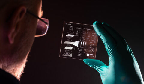Richard studies the glass platter containing drawings explaining how to read data in glass platters.