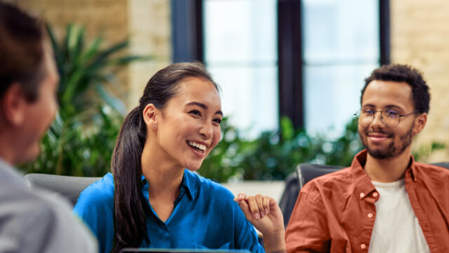 three people talking in a relaxed setting