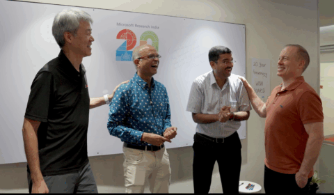 Peter Lee, Sriram Rajamani, Venkat Padmanabhan, and Doug Burger standing together smiling