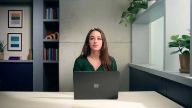 Jeanine Mason sitting at a table with a laptop