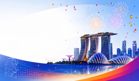 Illustrated Singapore skyline at dusk featuring Marina Bay Sands and Gardens by the Bay, with colorful fireworks and confetti overhead. Blue and orange graphic waves frame the scene, with a Merlion outline in the lower left and open space on the left for text.