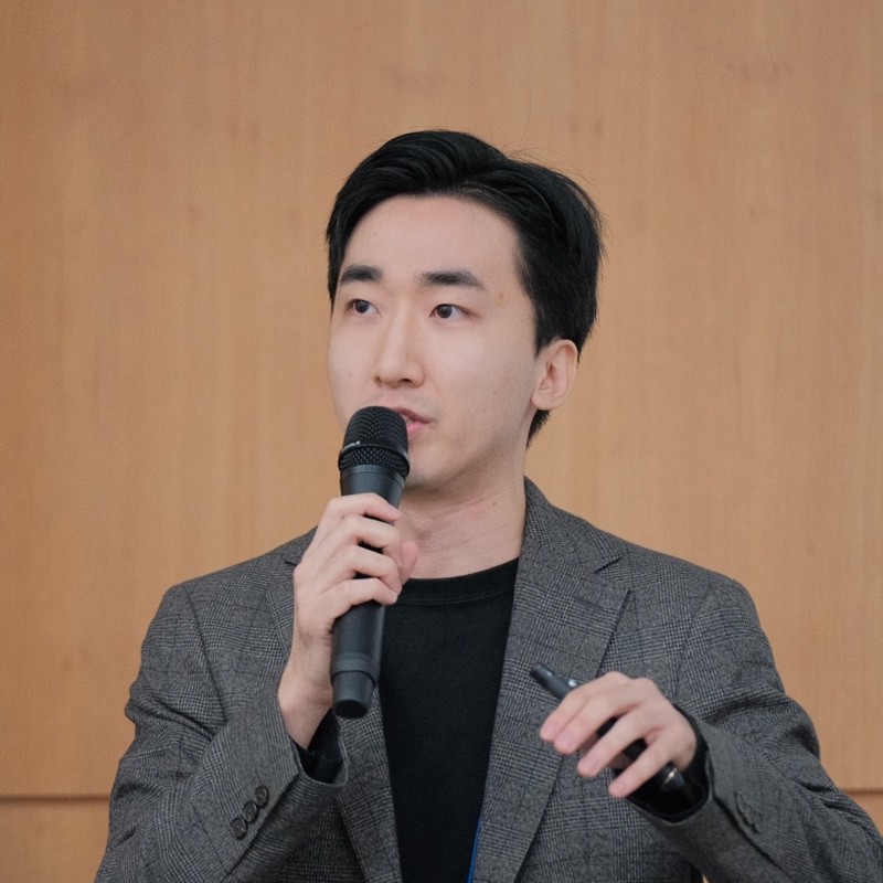 Hojun Jin holding a microphone