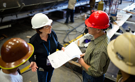 Image of workers on the floor in a factory.