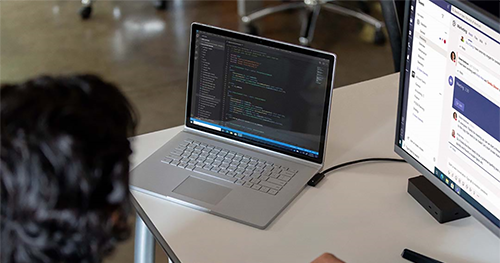 An image of adult male at desk workstation on a Surface Book 3.