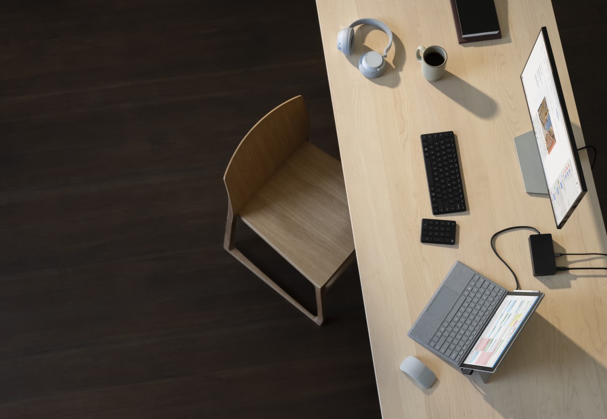 Surface Pro 7 inside alone at desk with Outlook on screen. Also pictured, Surface Headphones, Surface Dock 2, Surface Arc Mouse and Microsoft wireless keyboard