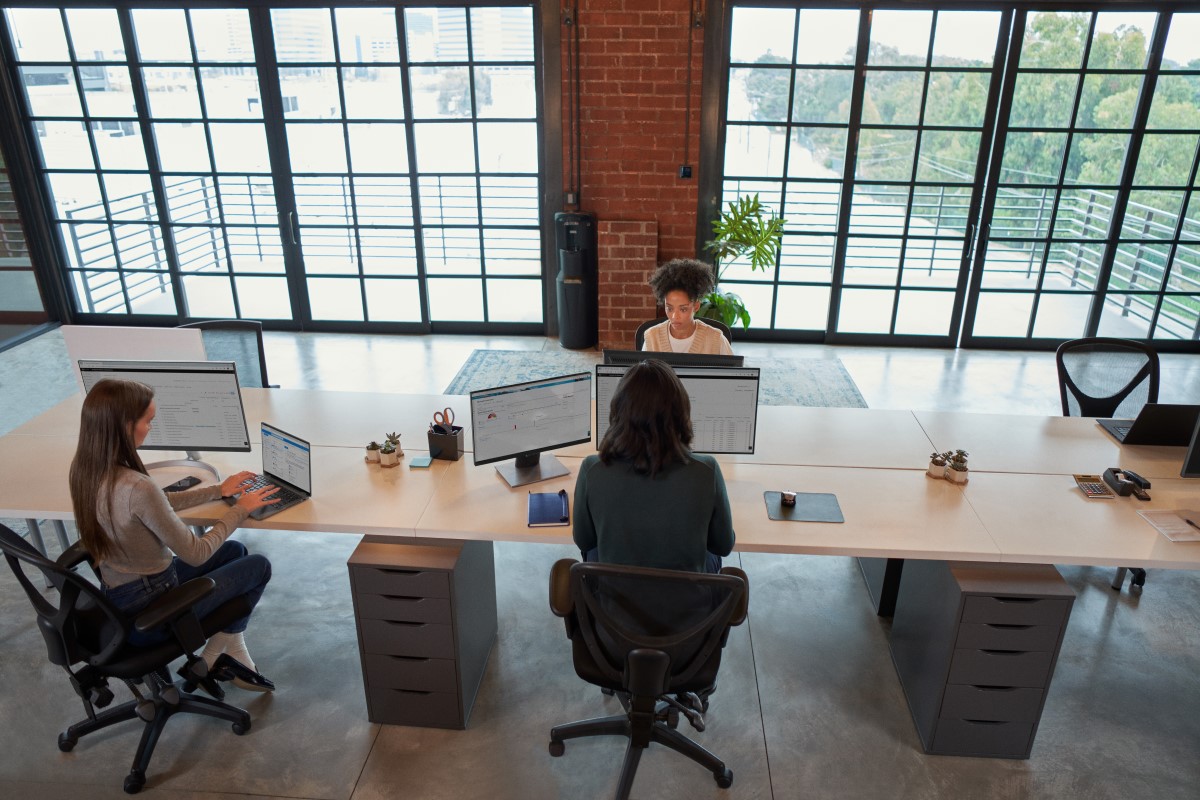 Enterprise office workers in focused work in an open work space.