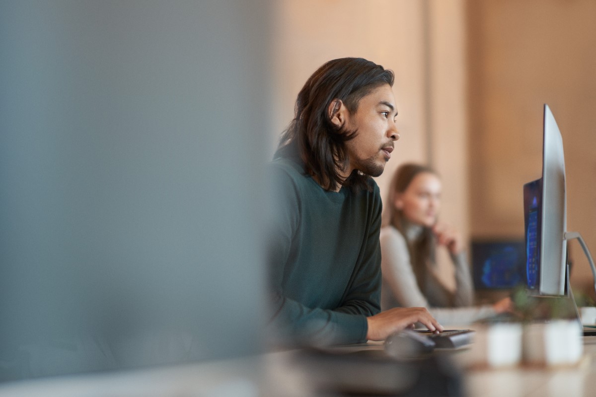 Worker in focused work with a neutral facial expression.