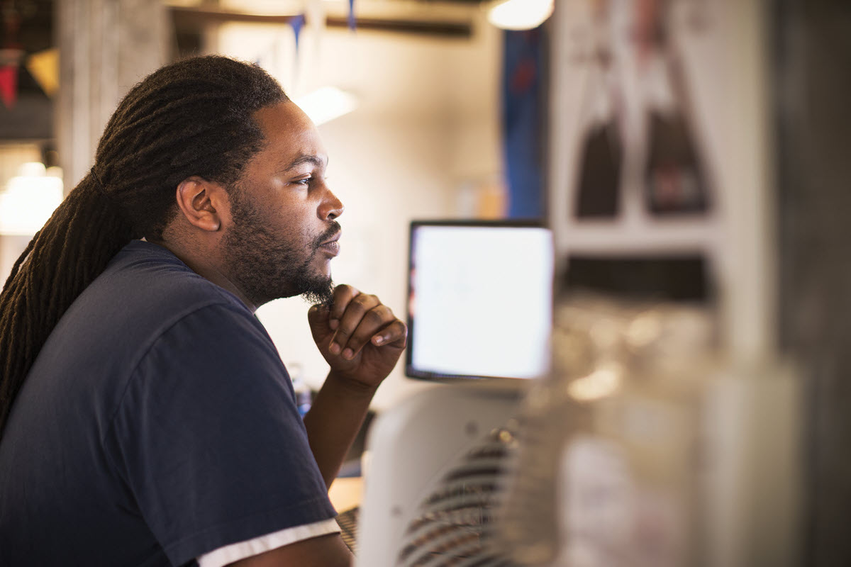 a man standing in front of a computer