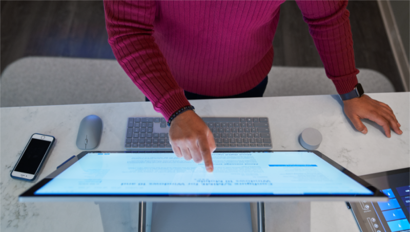 A man pointing at a computer screen.