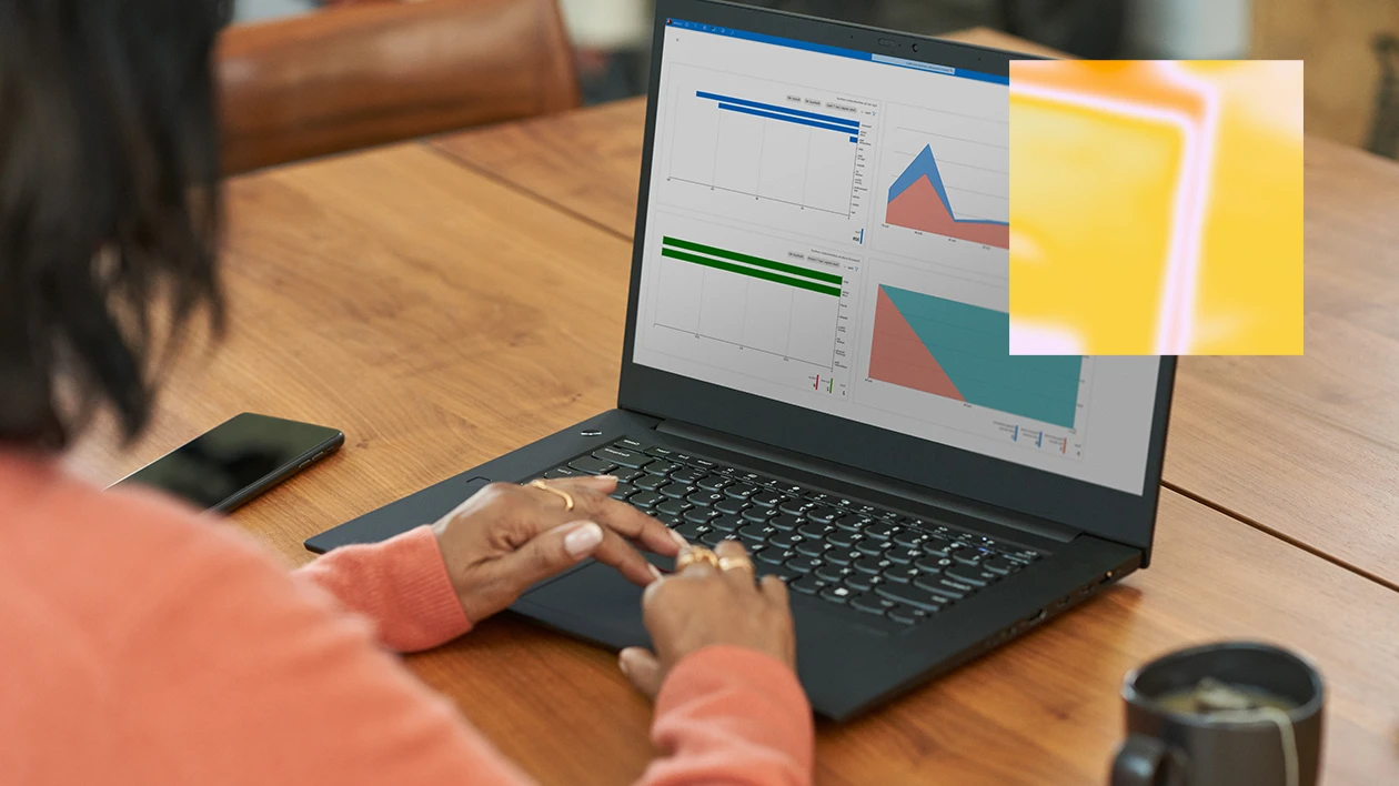 A person at a desk using a laptop.