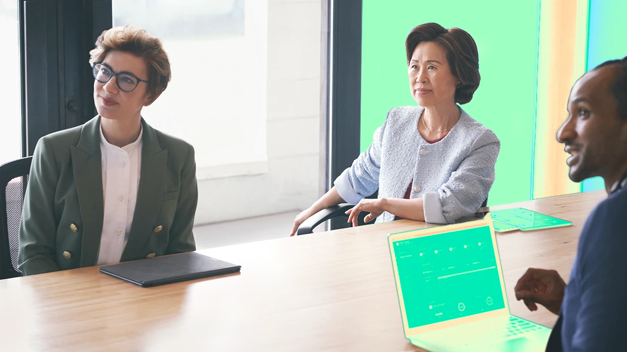 Two women sitting at a conference table.
