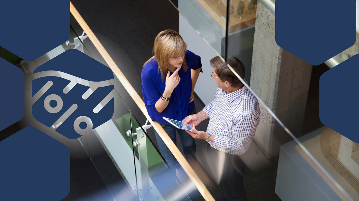 Two office workers talking in a hallway