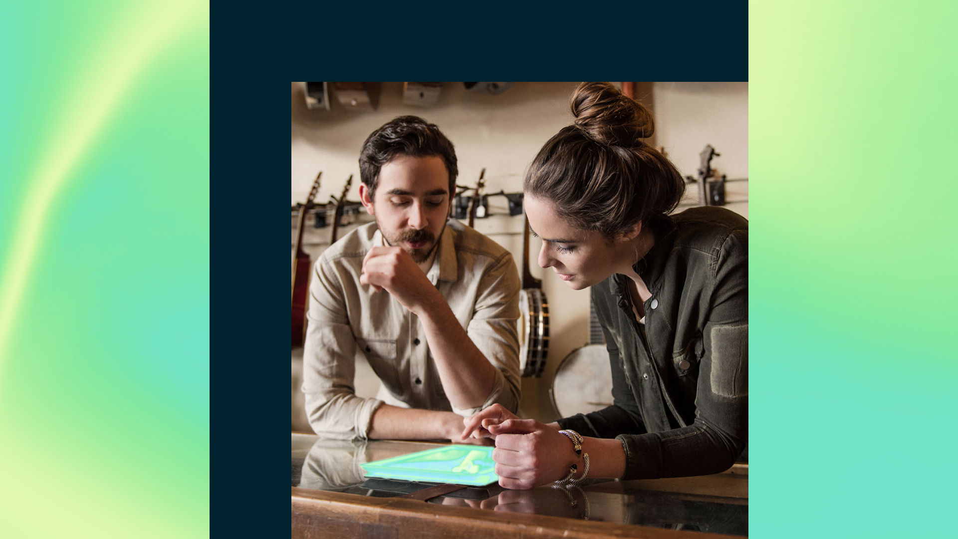Two people look at a tablet together.