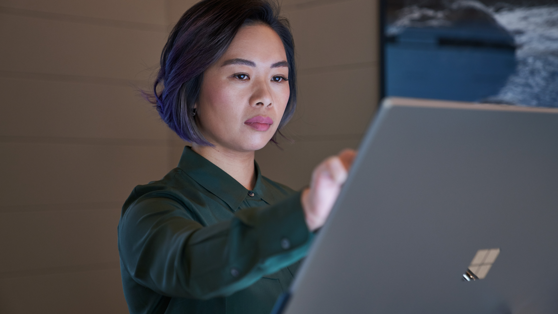 Professional woman looking at a Microsoft screen