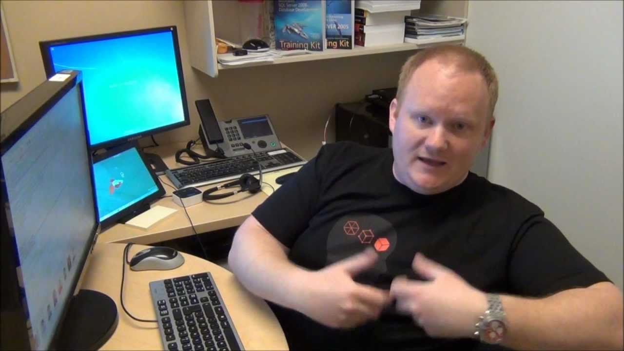 a person sitting at a desk in front of a laptop computer