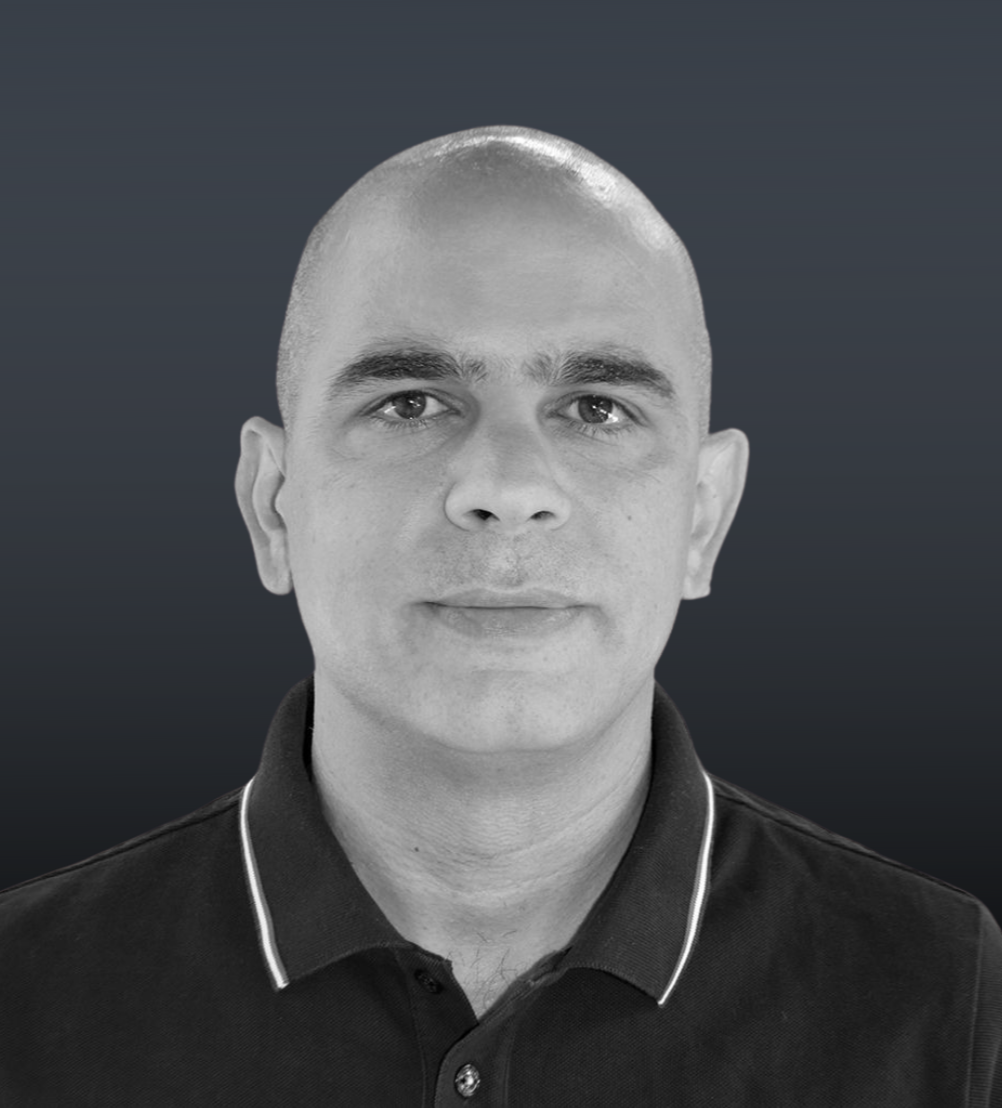 a man who is smiling and looking at the camera