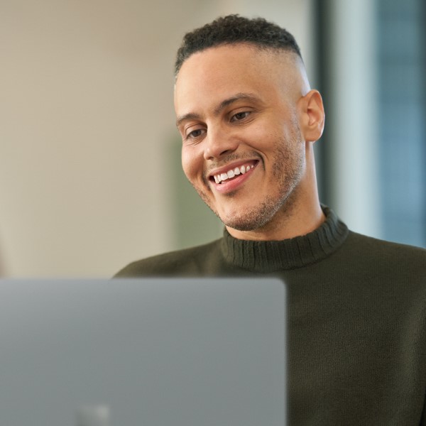 Person smiling while working on computer
