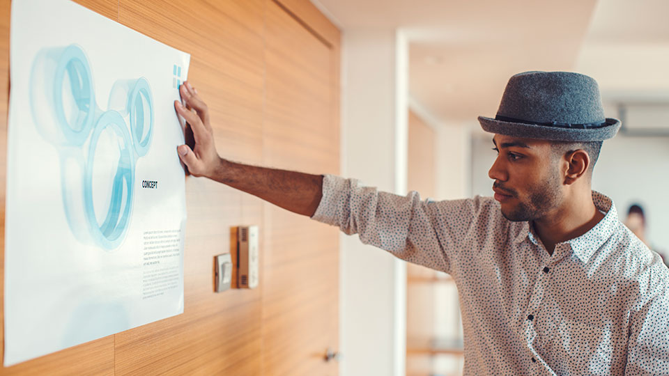 A man examines a wall poster