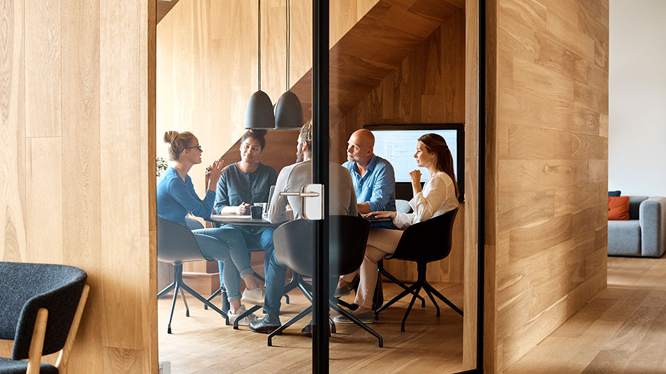 A group of coworkers having a discussion in a conference room
