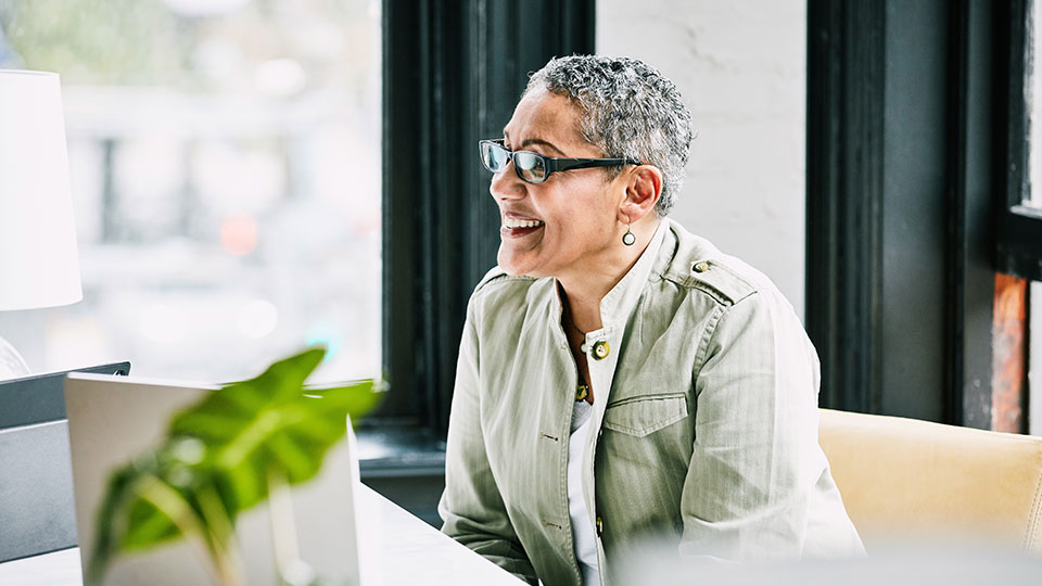 A smiling woman at a desk