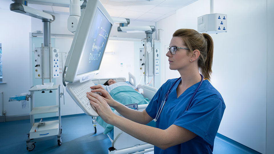 A radiologist consults a computer in an imaging suite