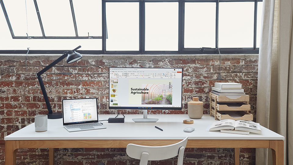 A computer workstation lit by bright windows