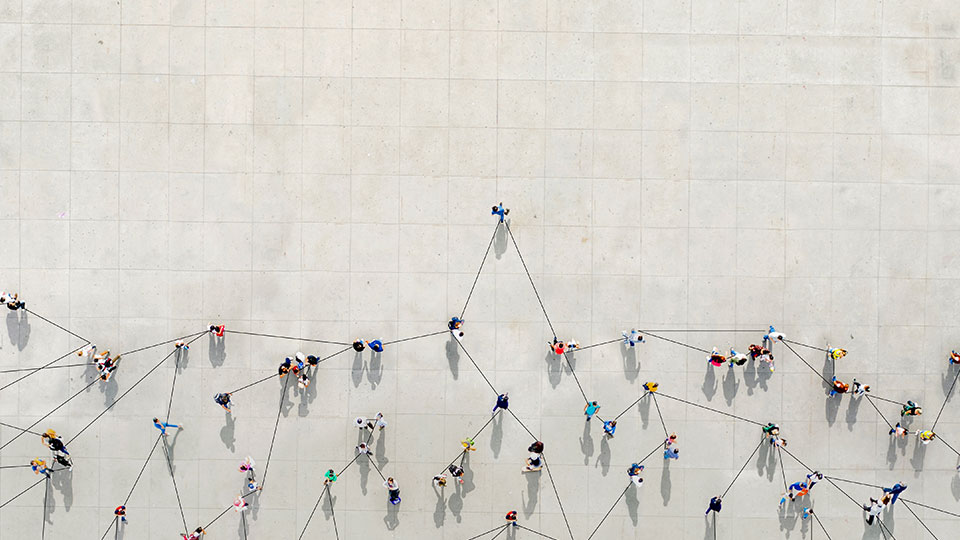 An overhead view of people walking with an abstraction of lines connecting them