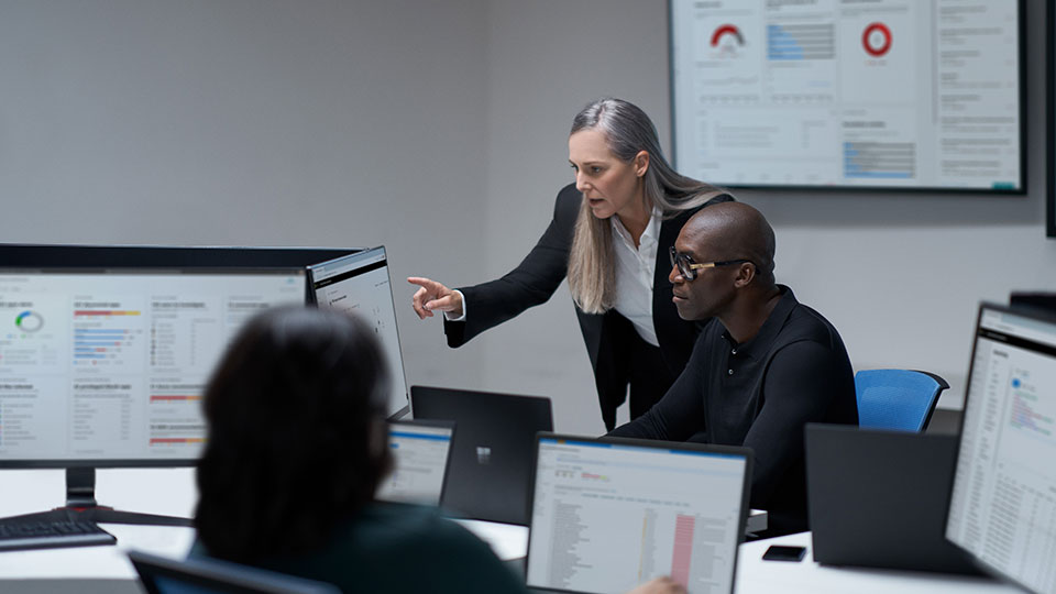 Two people read data on a monitor together
