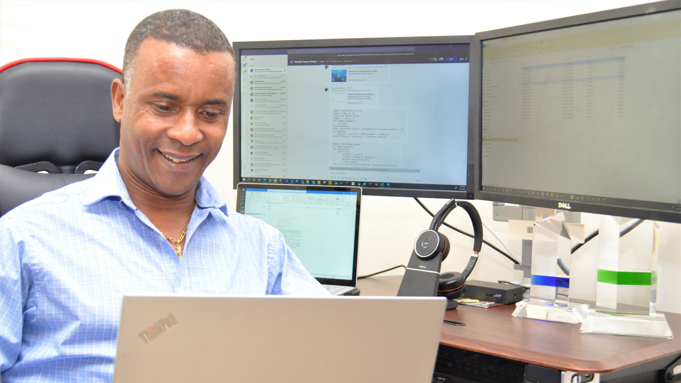 Photo shows Jembere as he works on a laptop computer.