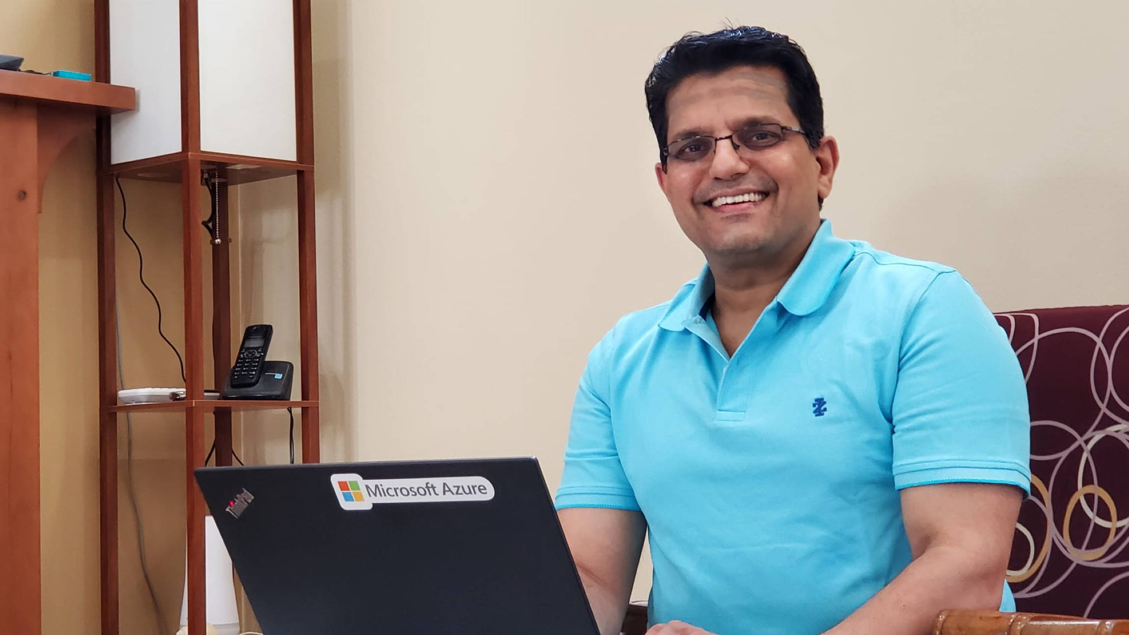 Venkatraman smiles at he sits in front of his laptop at his desk in his home office.