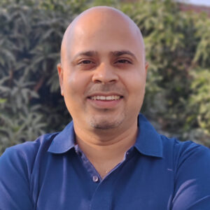 Pandey smiles in a close-up photo.