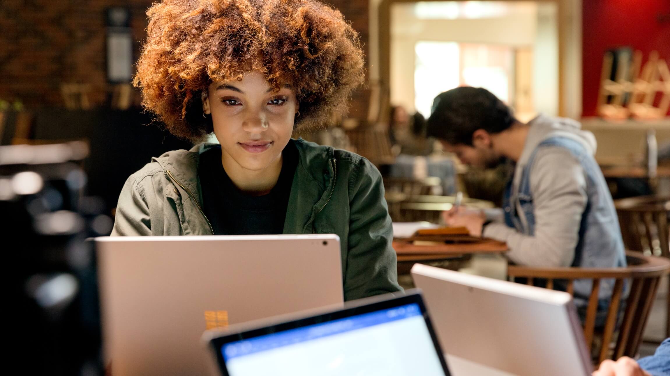 A person fills out a support request ticket on their work laptop.