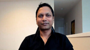 Jaysingh smiles as he interviewed at his desk in his home office.