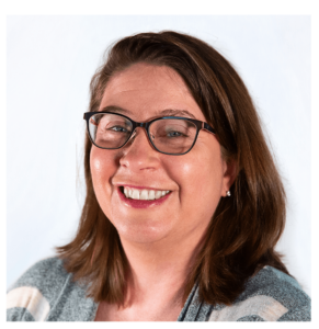 Lee smiles in a posed portrait photo.