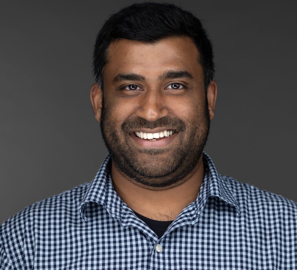 Vinoth smiles in a corporate photo. 