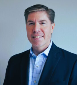 Buono smiles in a corporate photo.