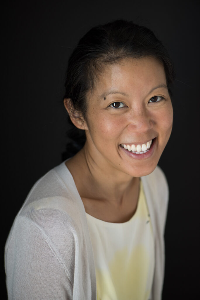 A photo of Tan smiling.