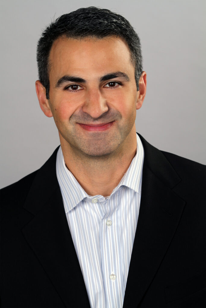 A photo of Nowbar smiling.