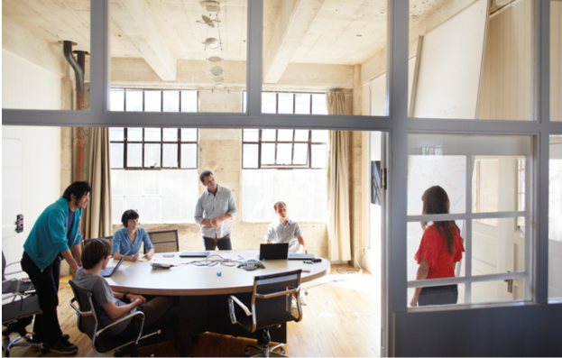 People sitting at a table in a big room