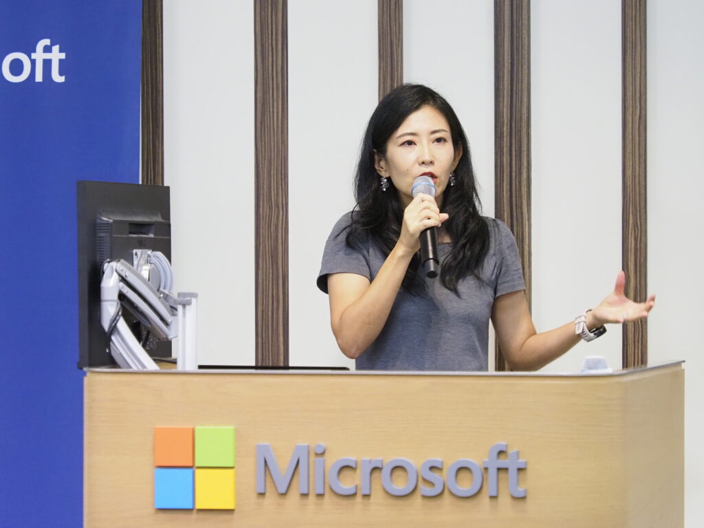 a woman speaking into a microphone