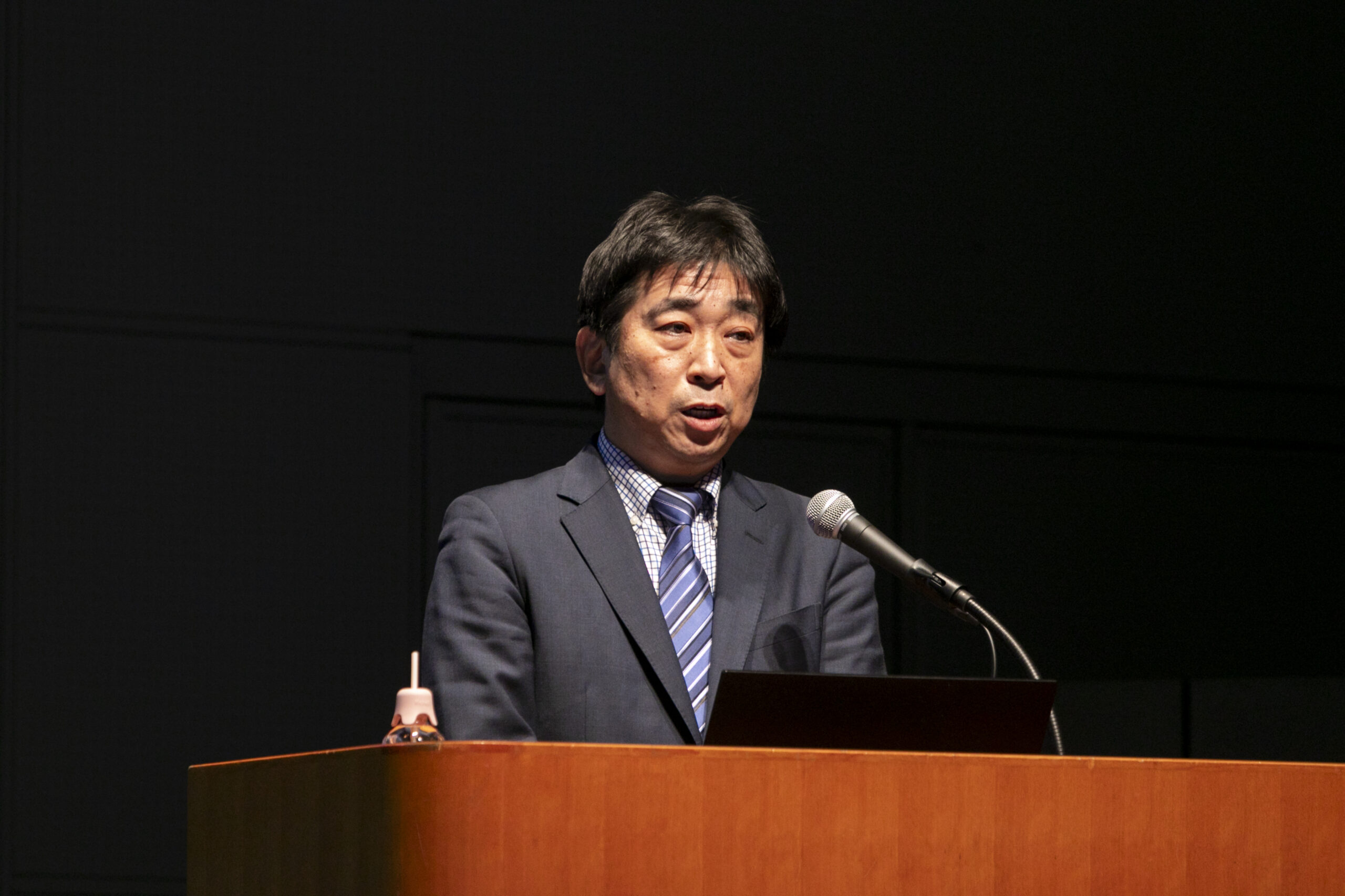 A man standing at a podium with a microphone