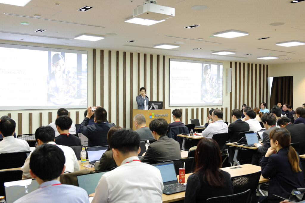 A woman standing in front of a group of people in a room