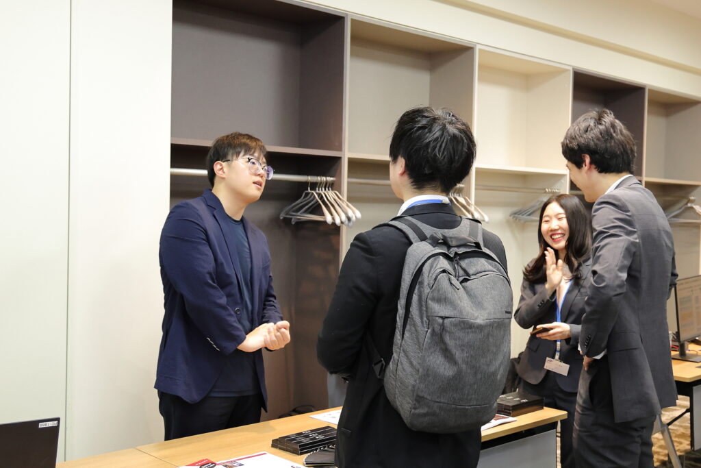 A group of people standing around a table