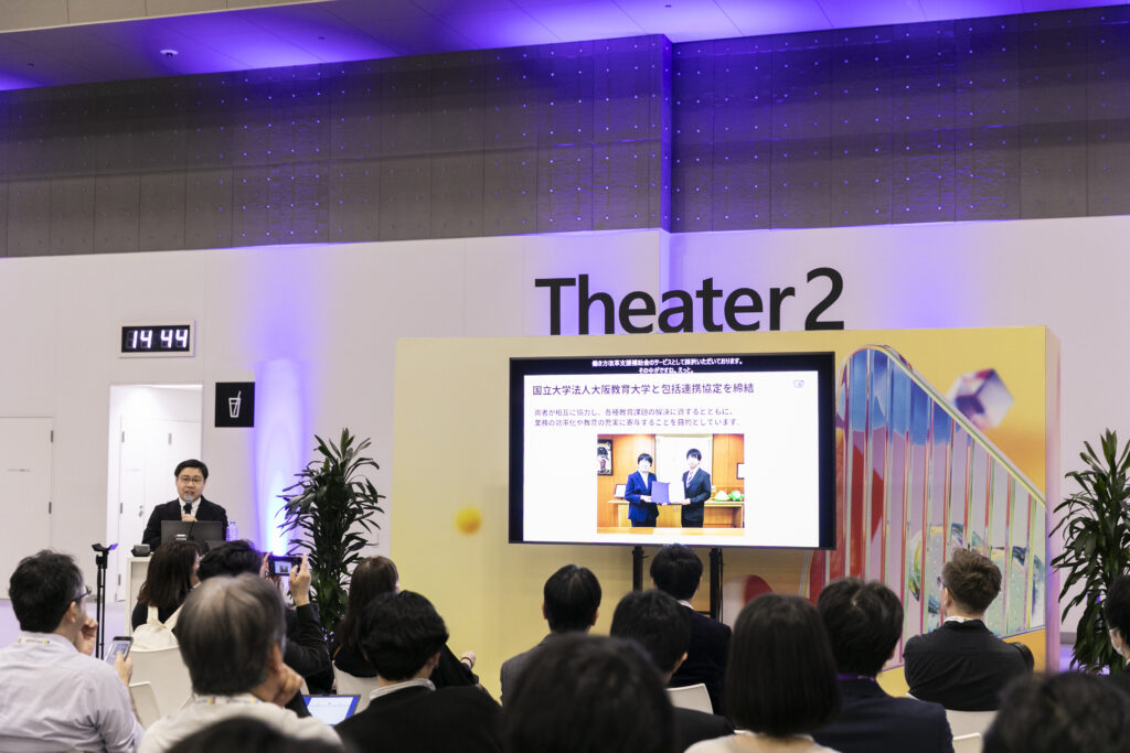 A man standing in front of a screen