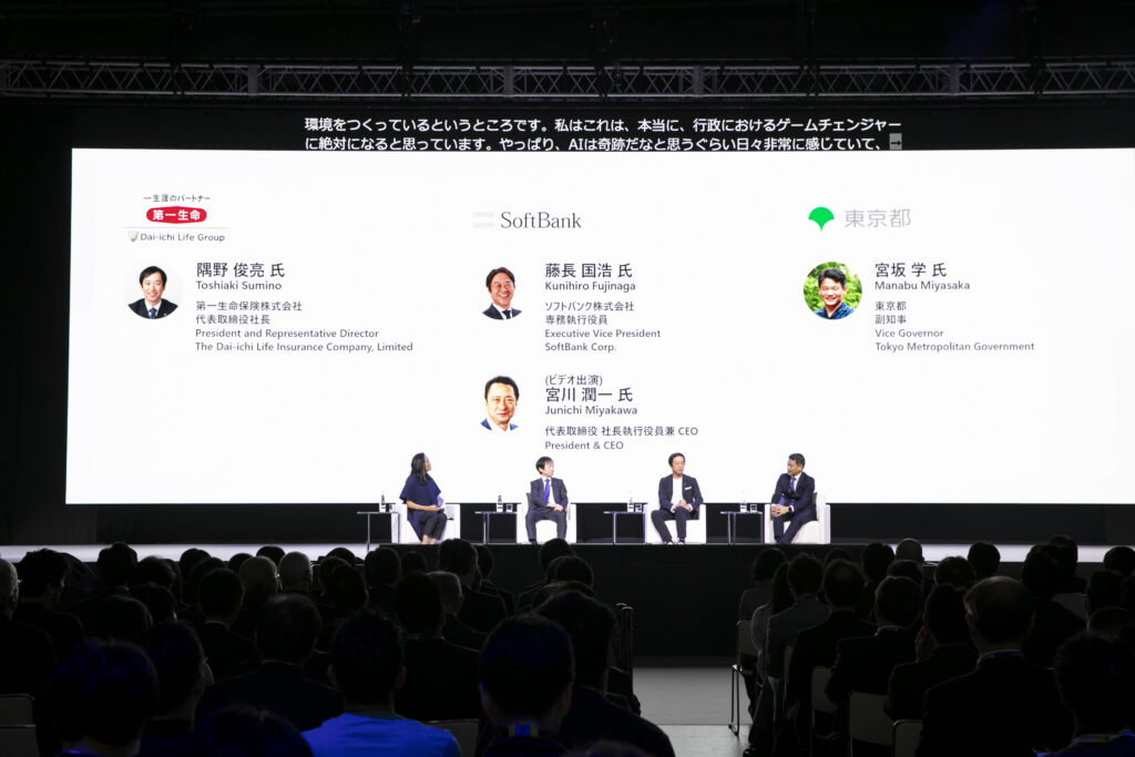 A group of people sitting in front of a large screen