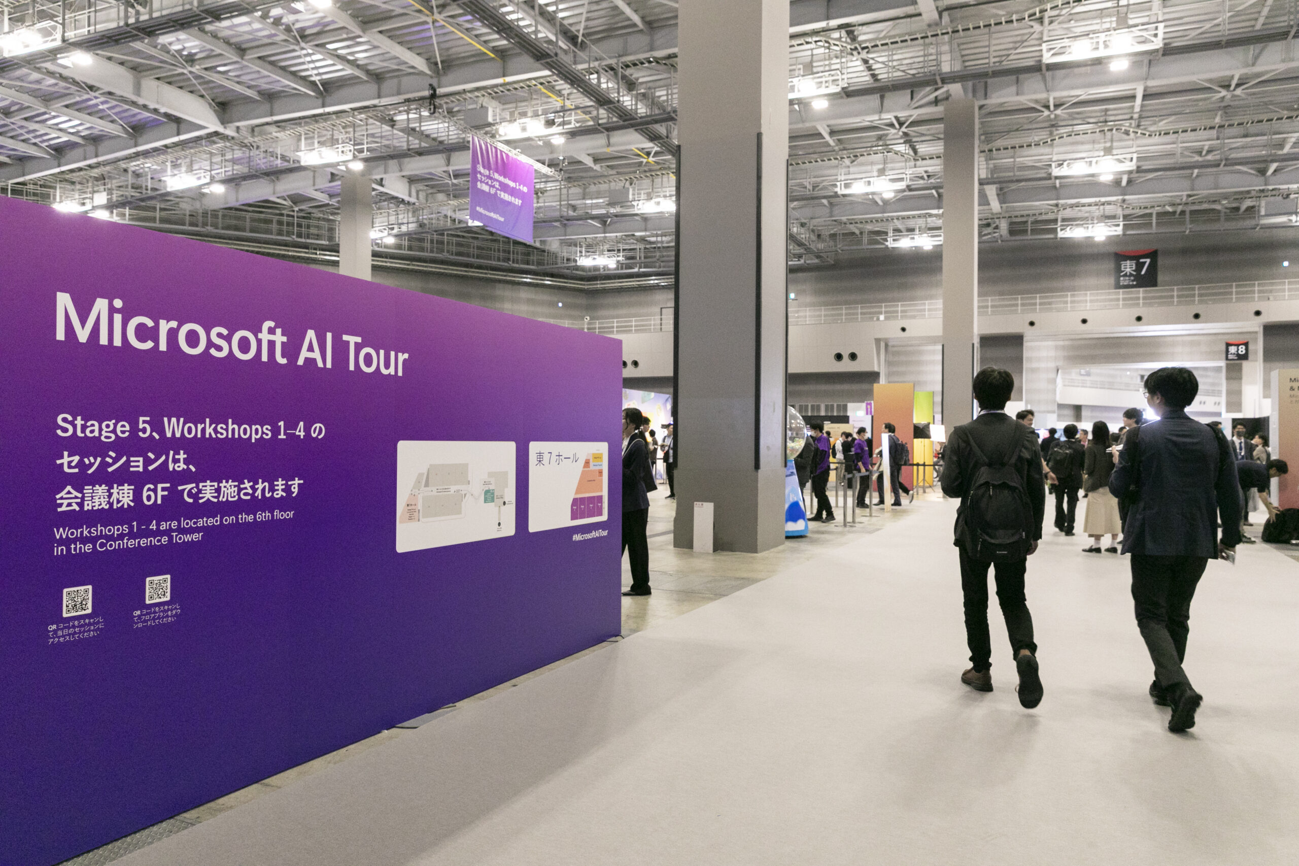 A group of people walking in a large room