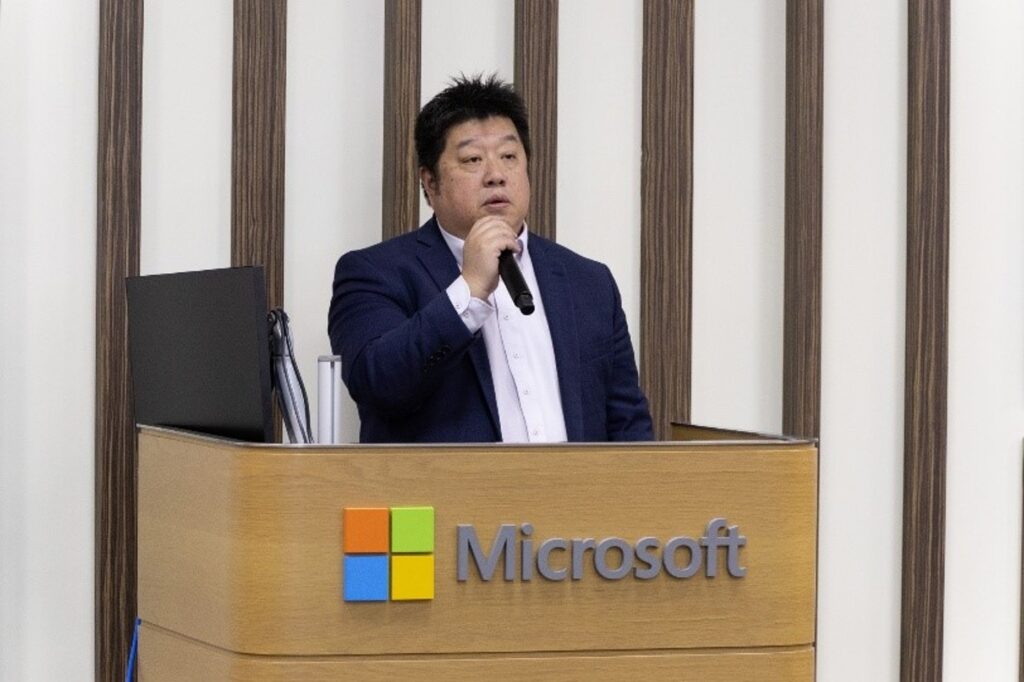 A man standing at a podium with a microphone